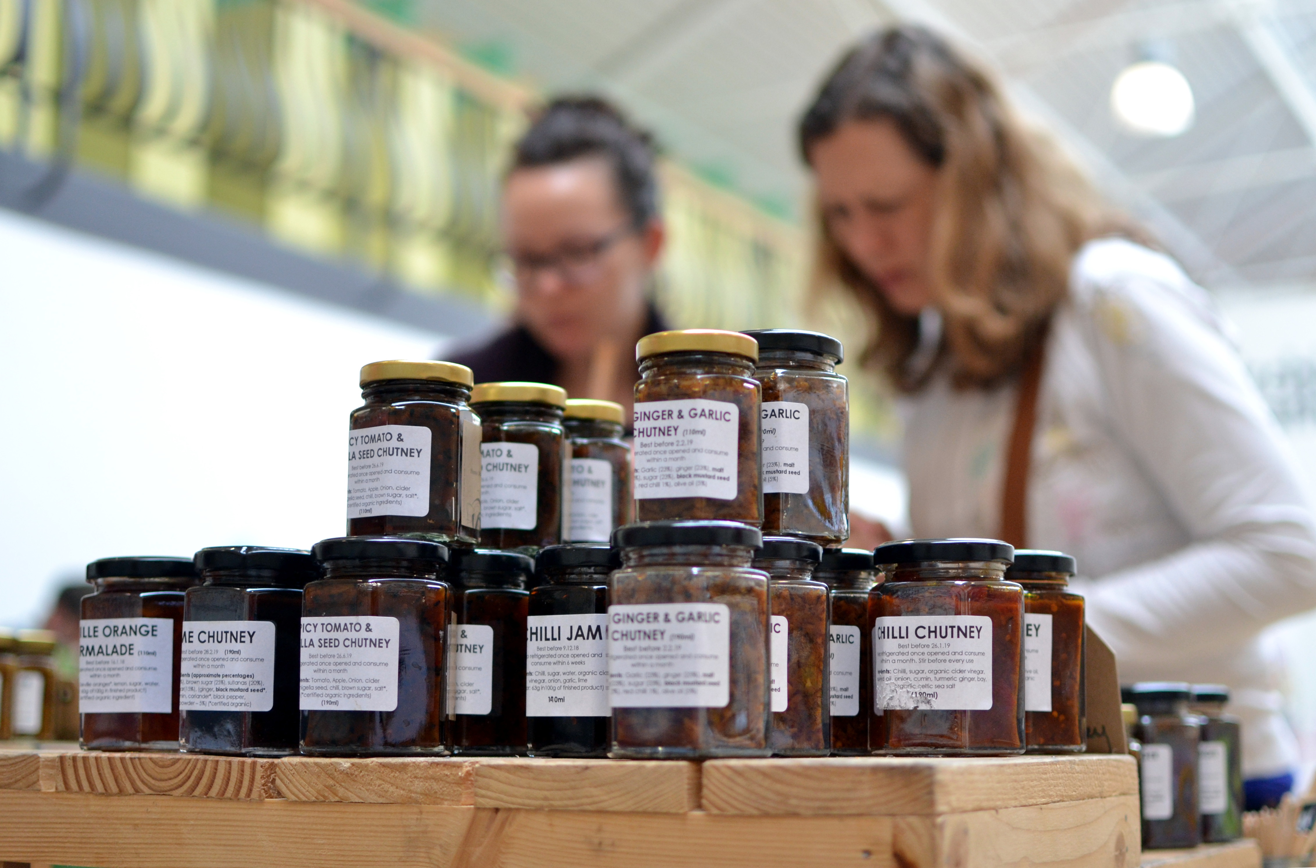Customers taking a close look at jars from Cuffufle Preserves