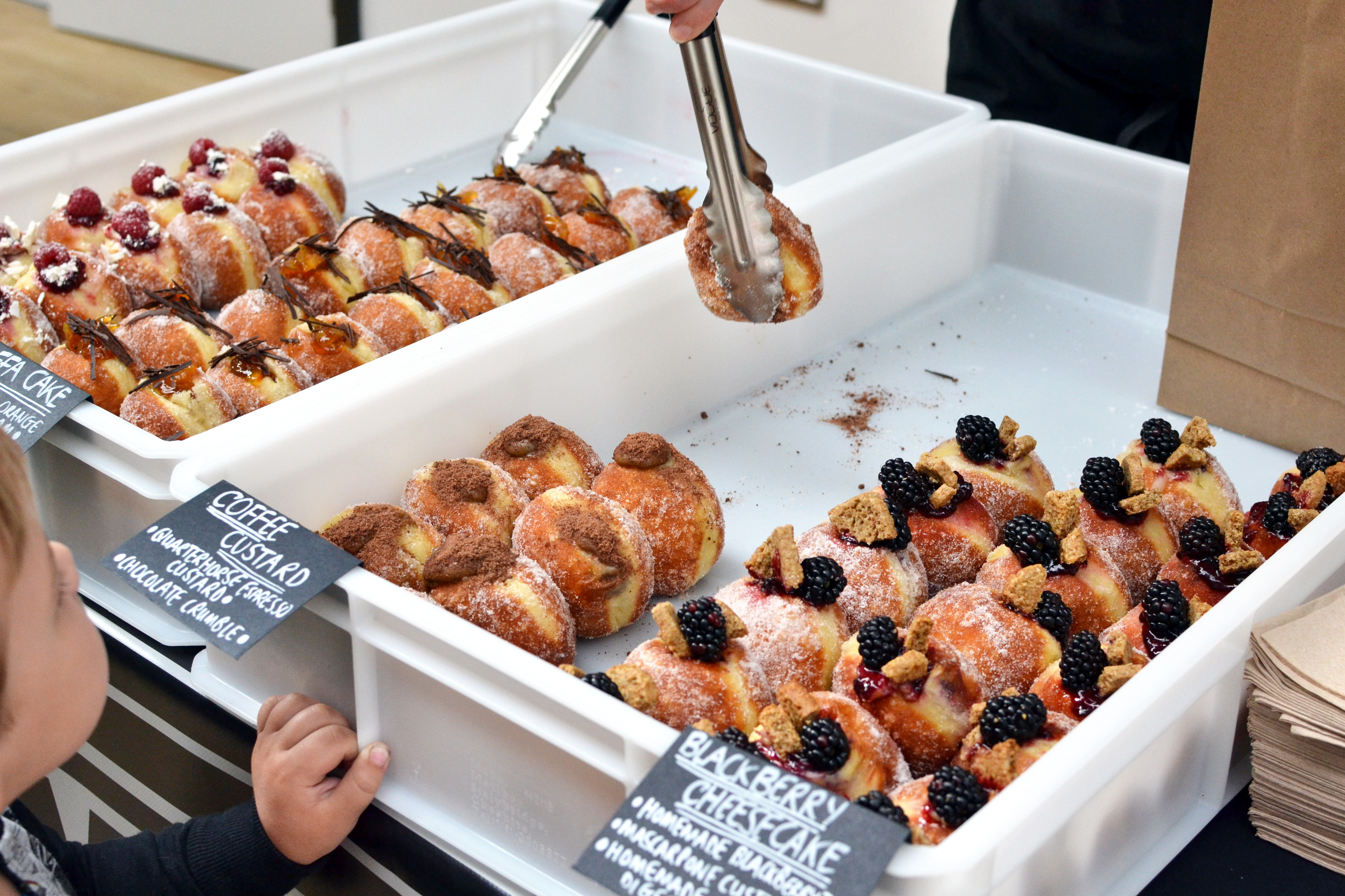 Serving doughnuts on the Jam vs Custard stall