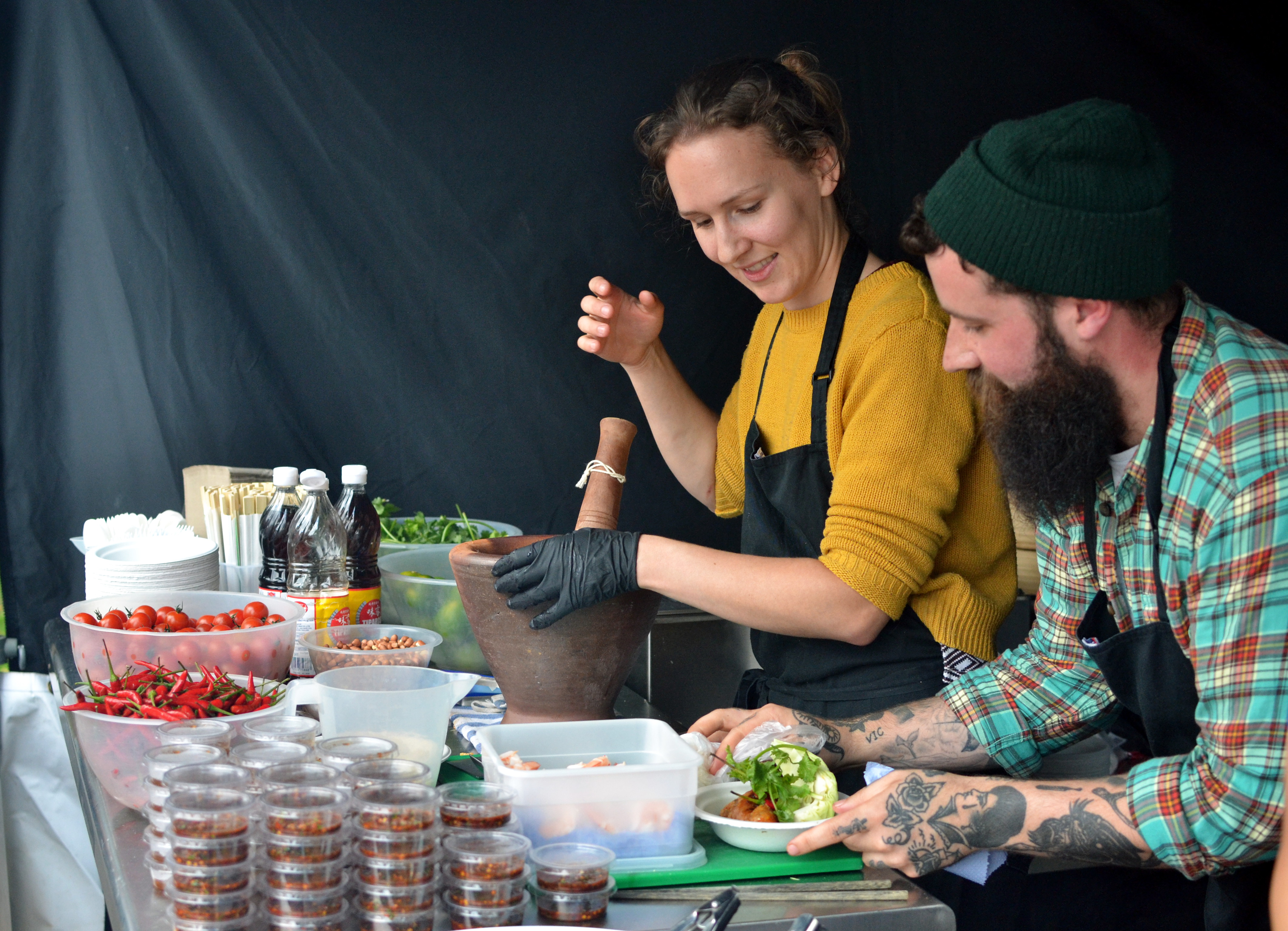 Preparing food on the Thai pop-up stall run by Loaf Community Bakery