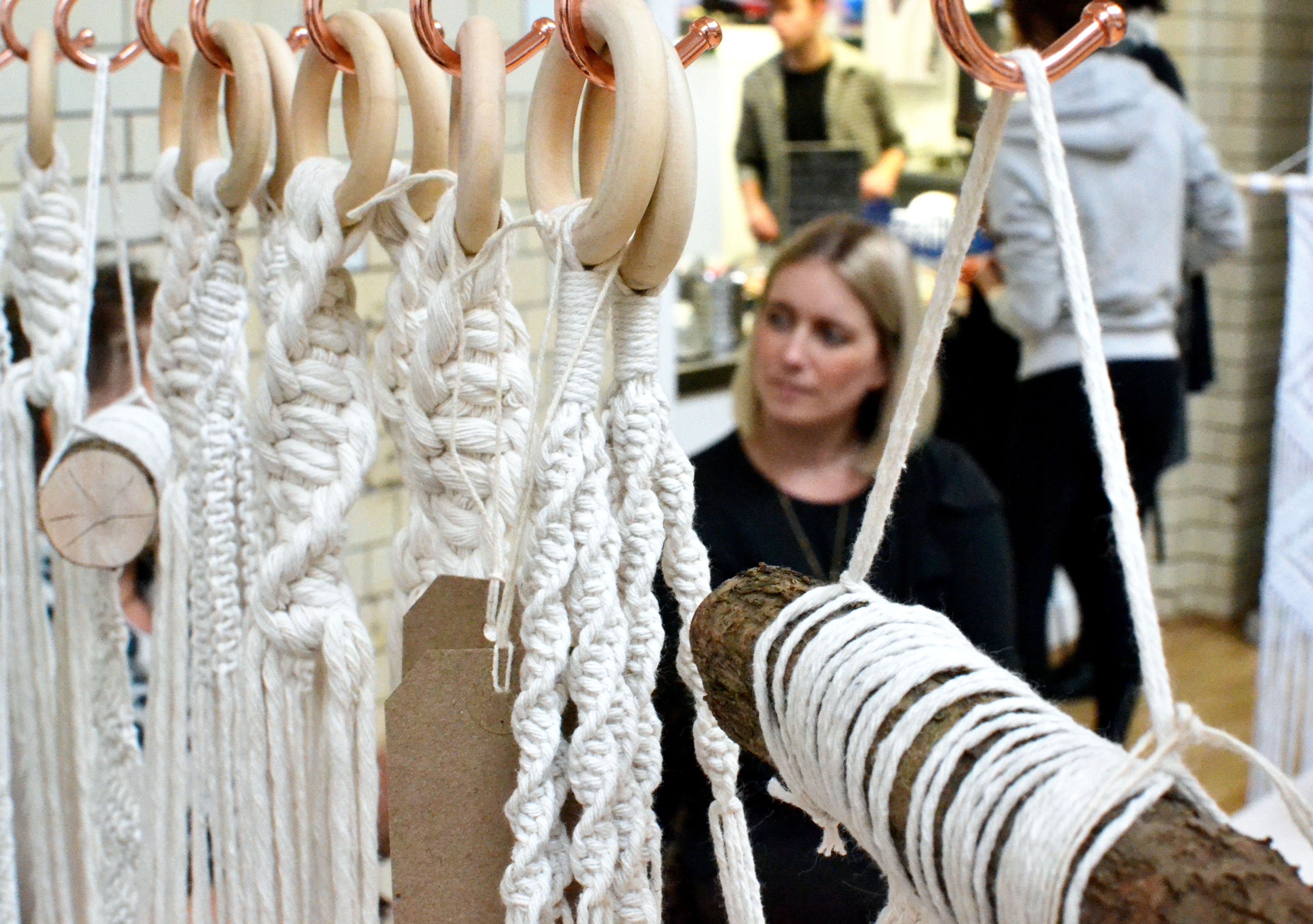 Amy sitting behind macramé products