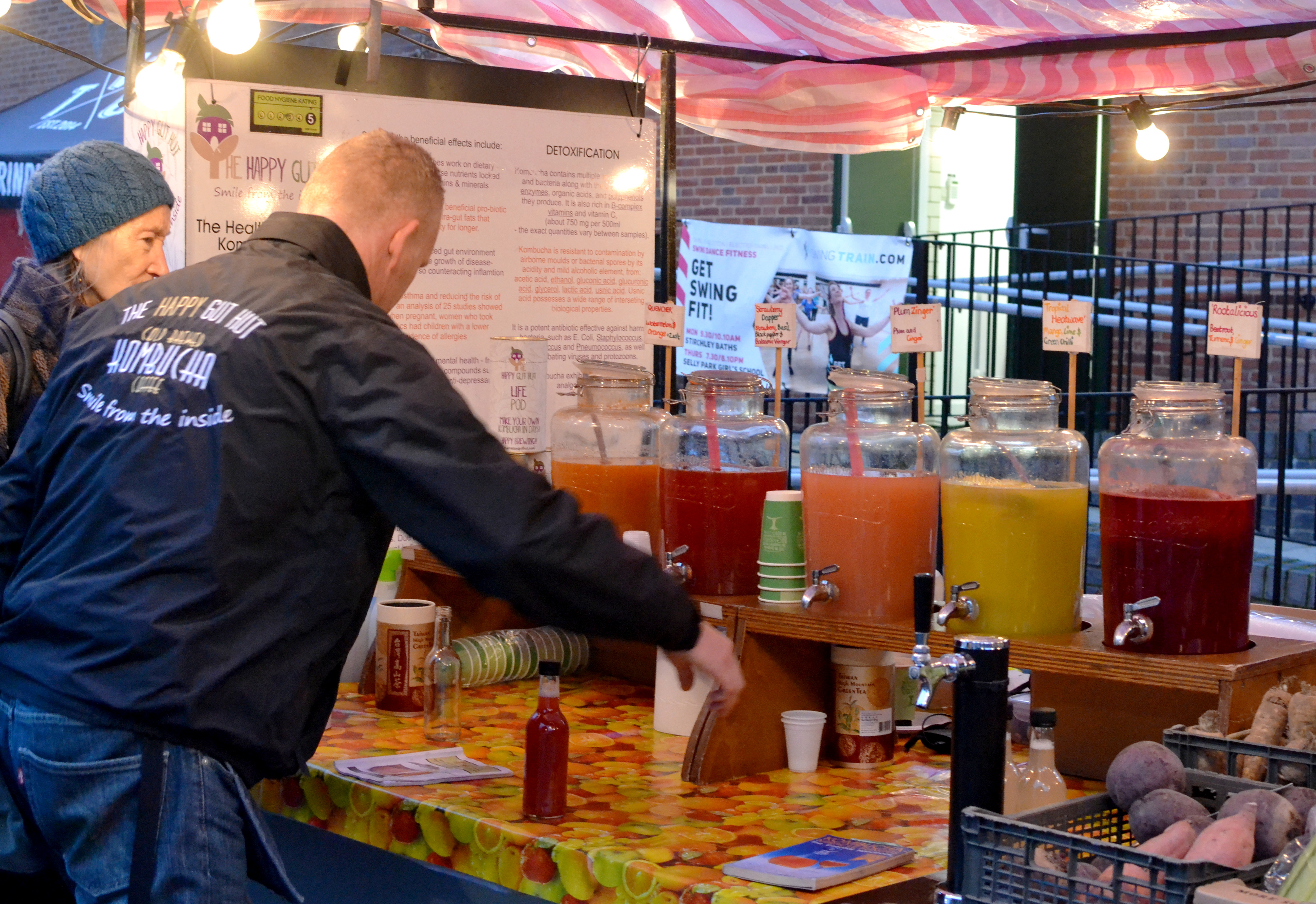 The Happy Gut Hut stall under the outdoor lights
