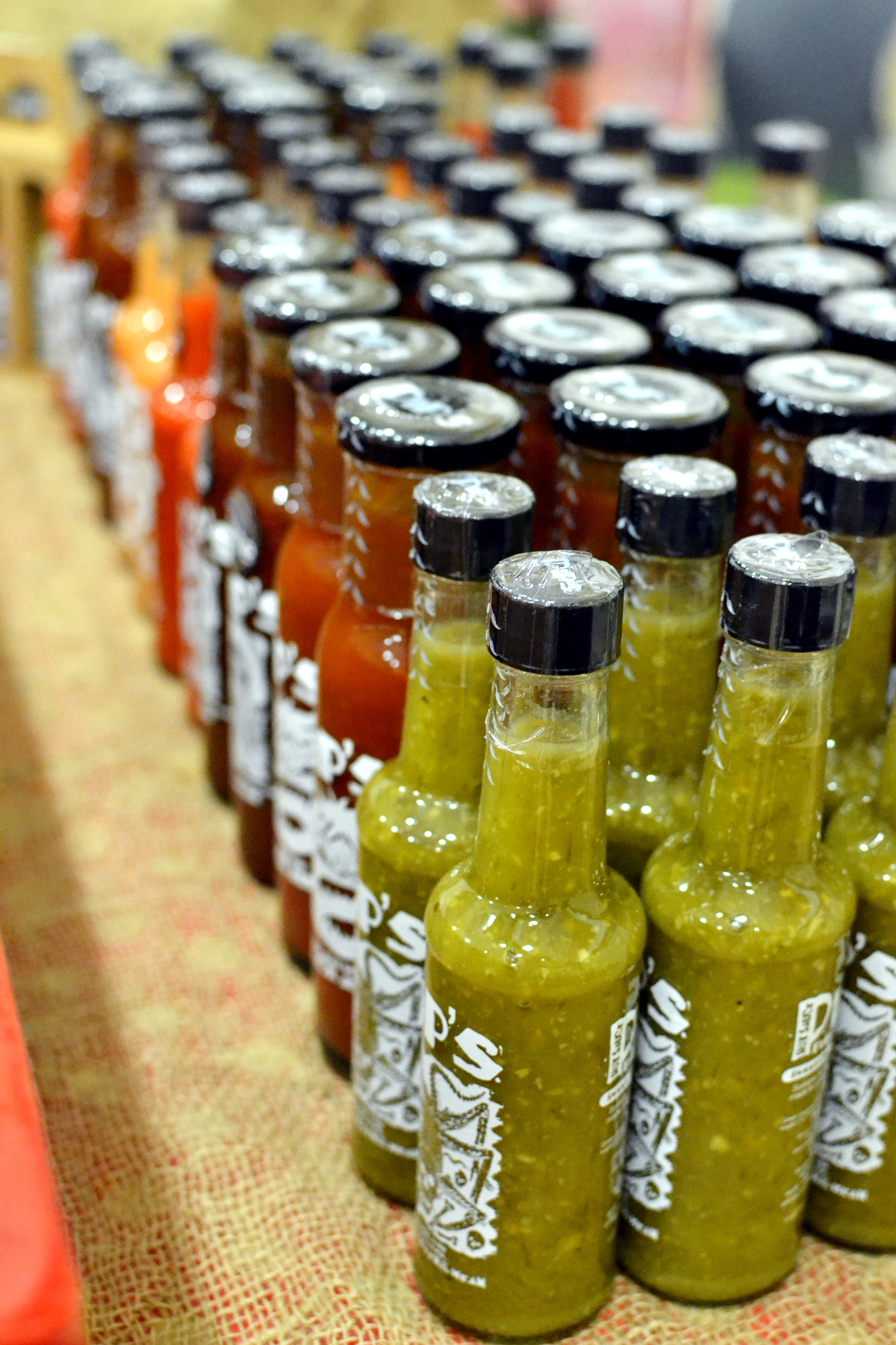 Rows of coloured sauce bottles