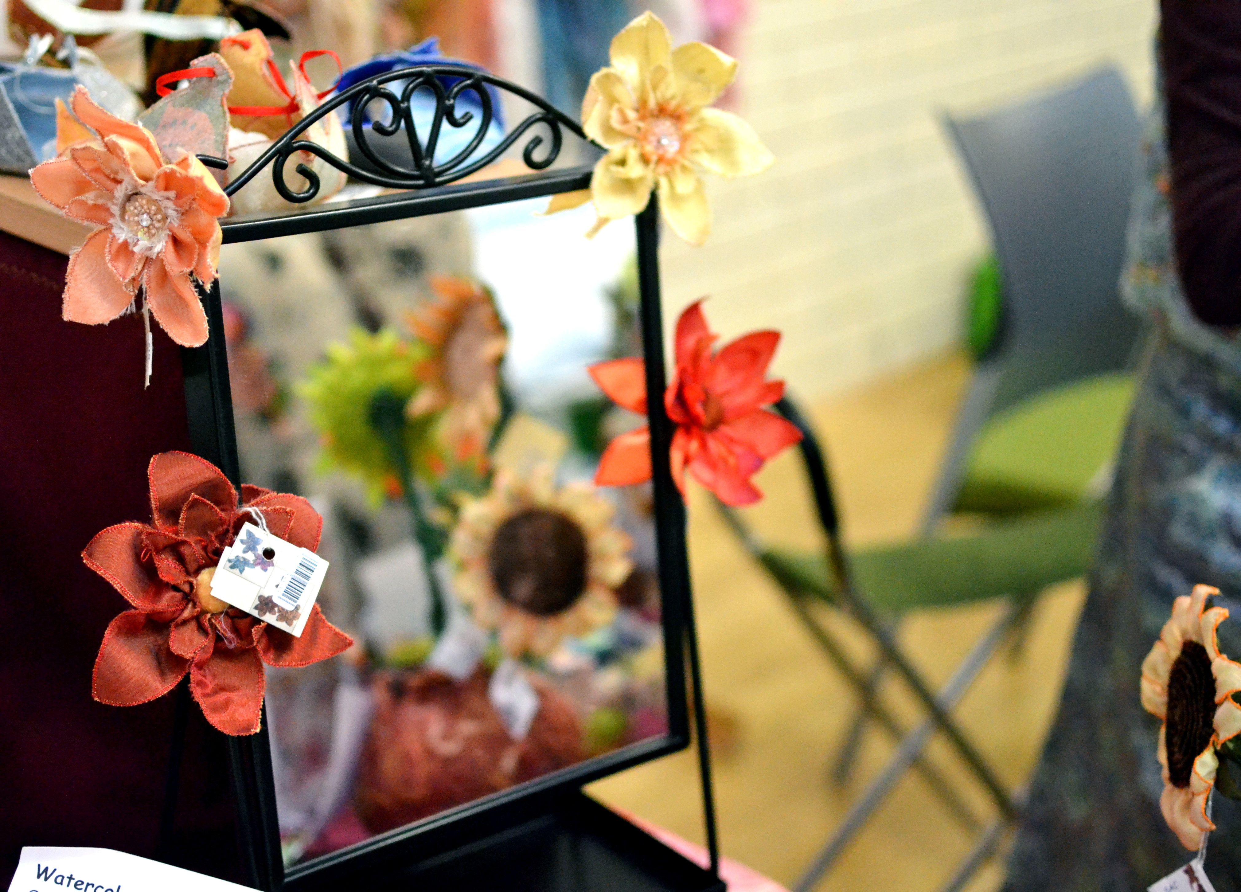 Fabric flowers reflected in a mirror