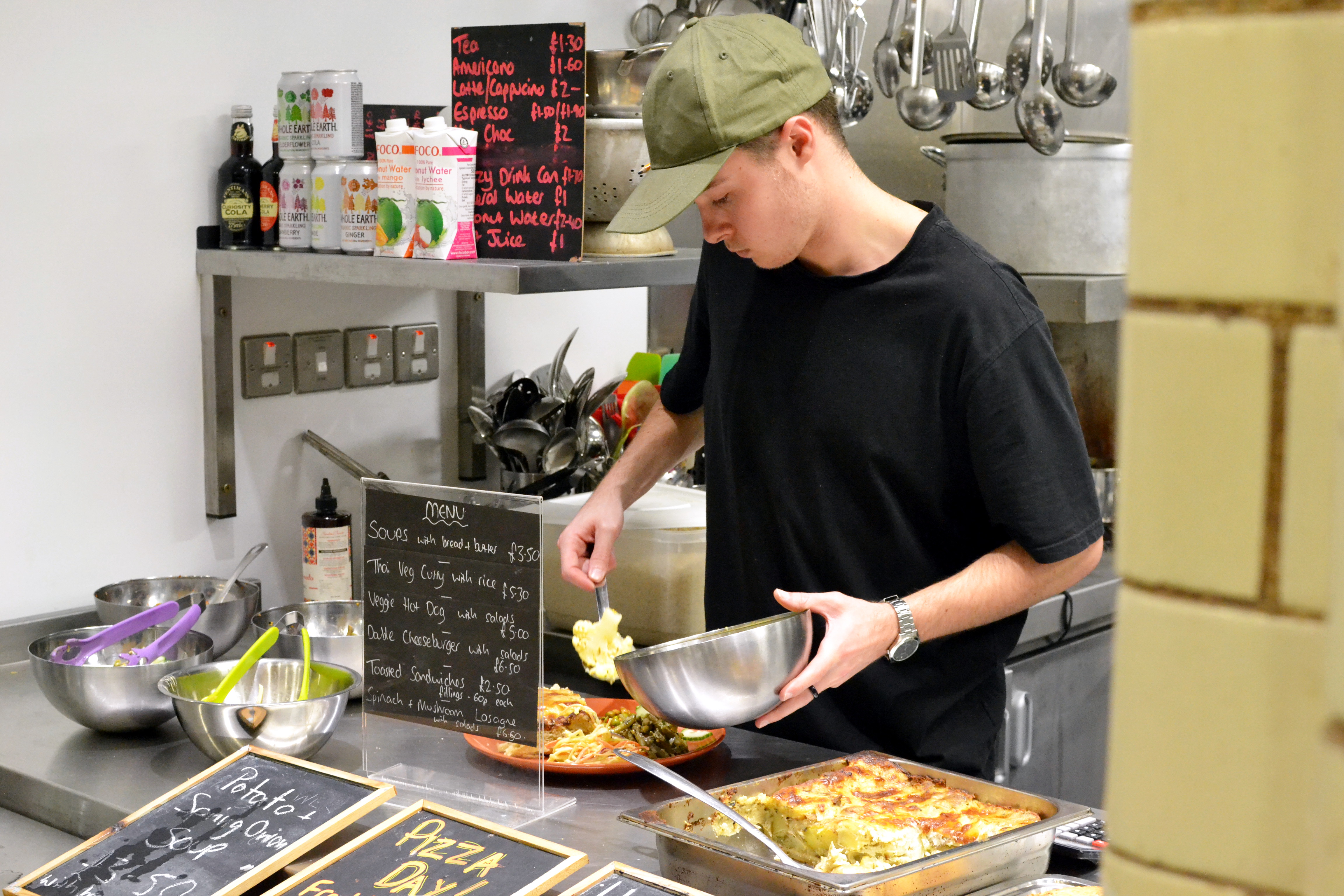 Putting food on a plate at the kitchen servery