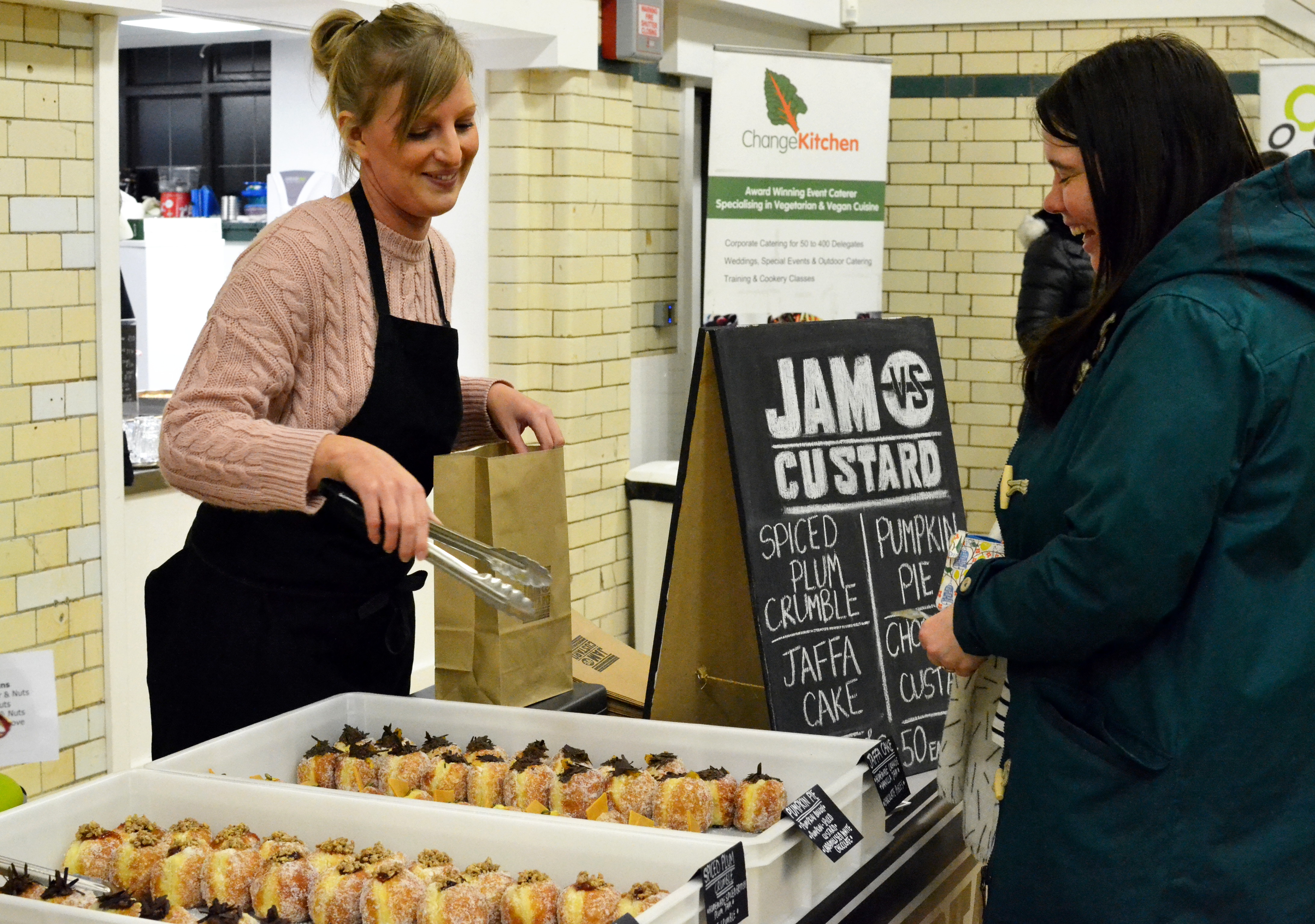 A customer at the Jam vs Custard stall