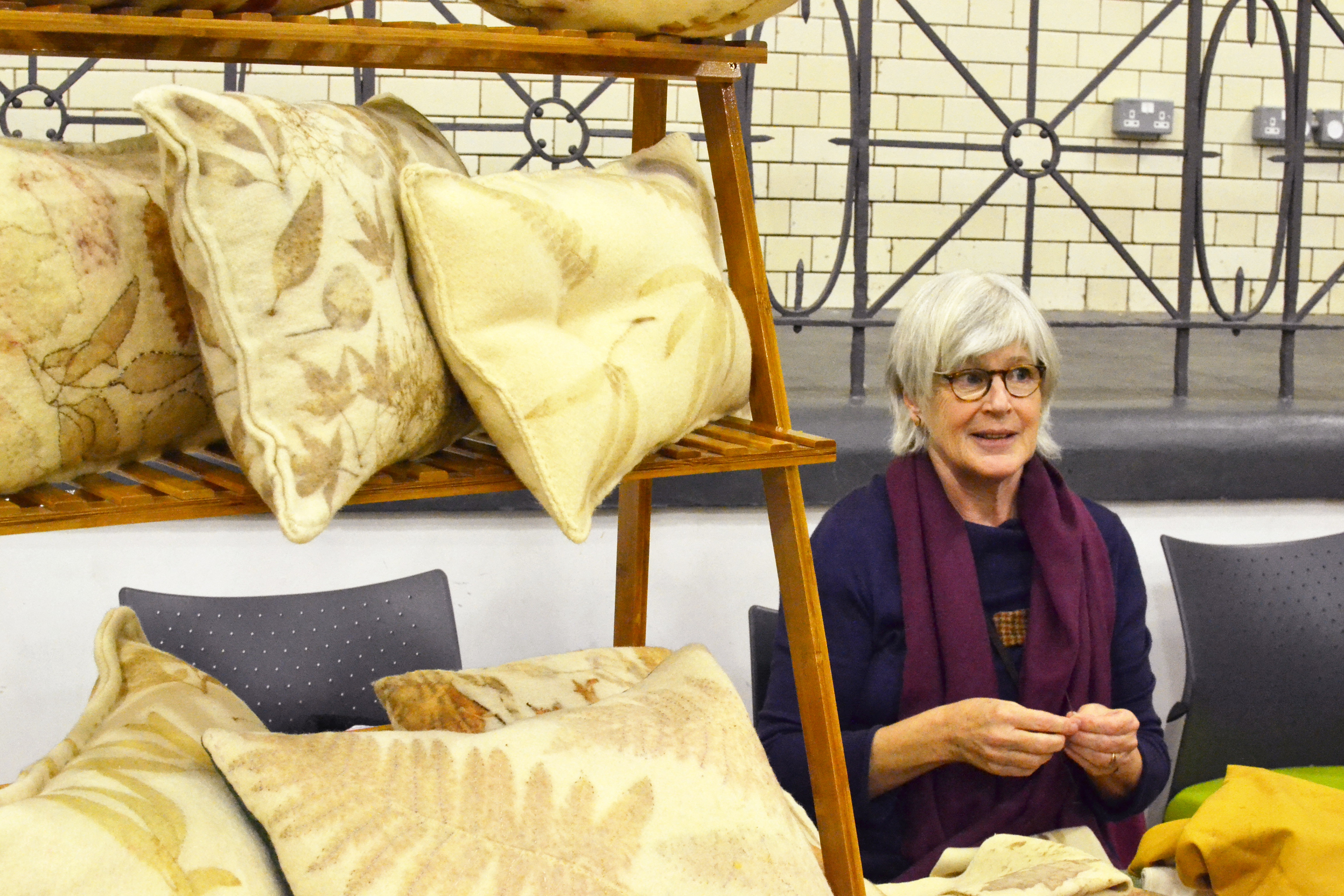 Lucy with a range of fabric-covered cushions