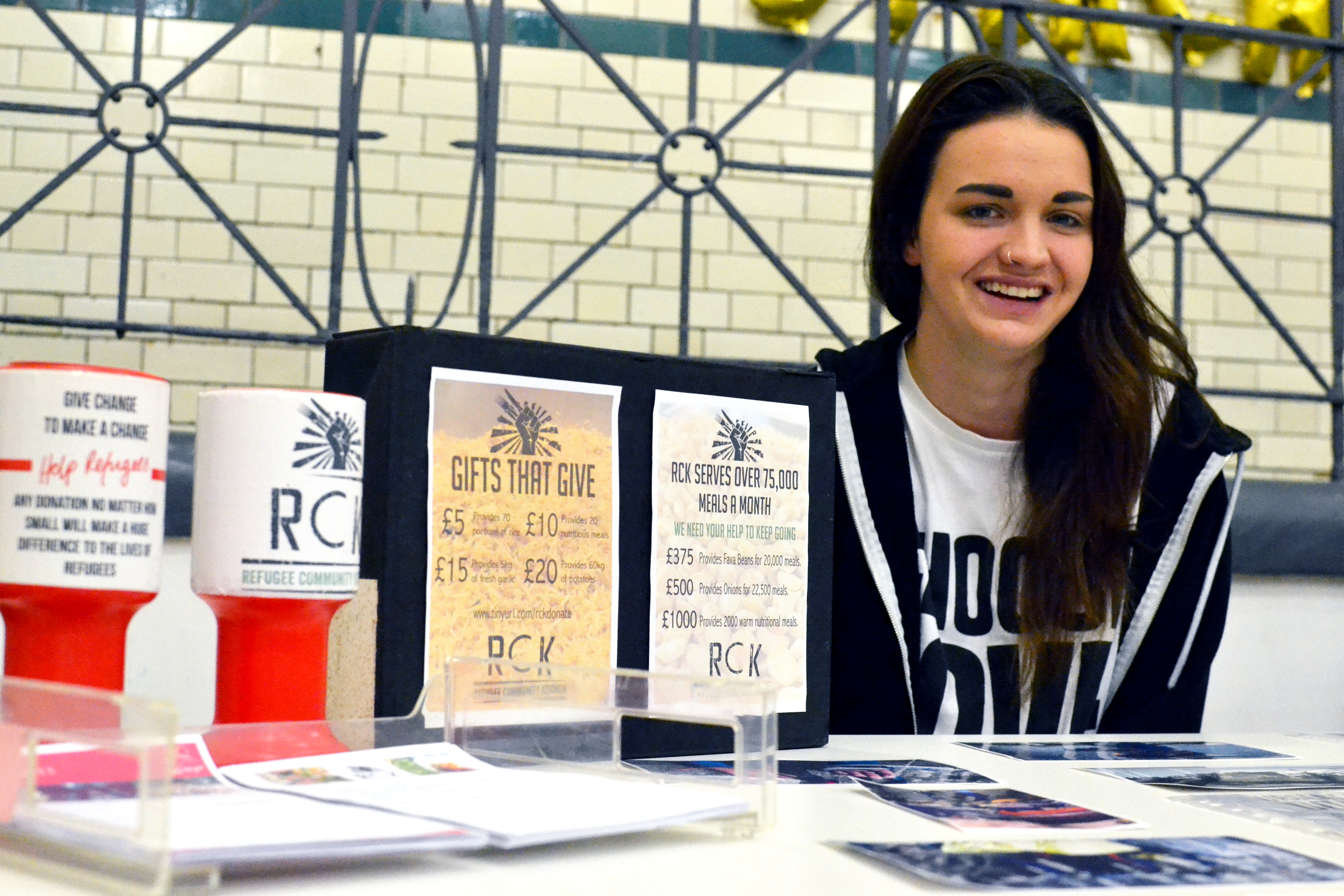 Collection tins and publicity on the Refugee Community Kitchen stall